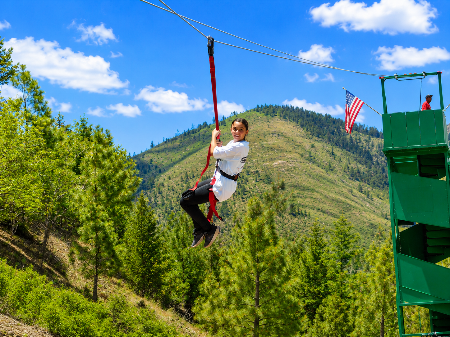 Guest riding the zipline with mountain views at Ruidoso's Winter Park